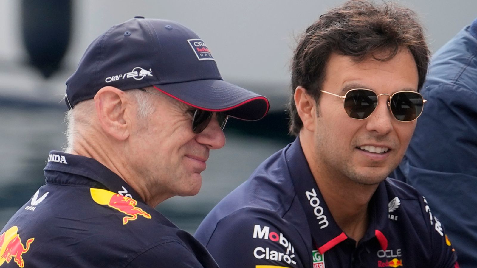 Red Bull technical director Adrian Newey is flanked by Red Bull driver Sergio Perez of Mexico and former F1 driver Alain Prost arrive ahead the third free practice, at the Monaco racetrack, in Monaco, Saturday, May 25, 2024. The Formula one race will be held on Sunday. (AP Photo/Luca Bruno)