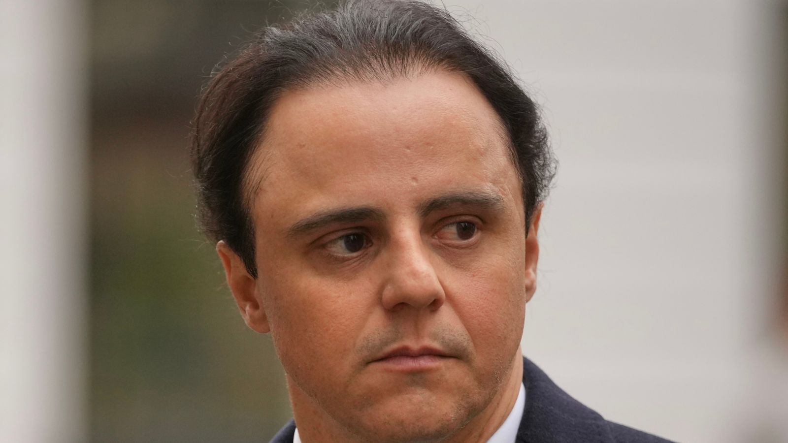 Former Ferrari Formula  driver Felipe Massa leaves the Royal Courts of Justice in London (AP Photo/Kin Cheung)