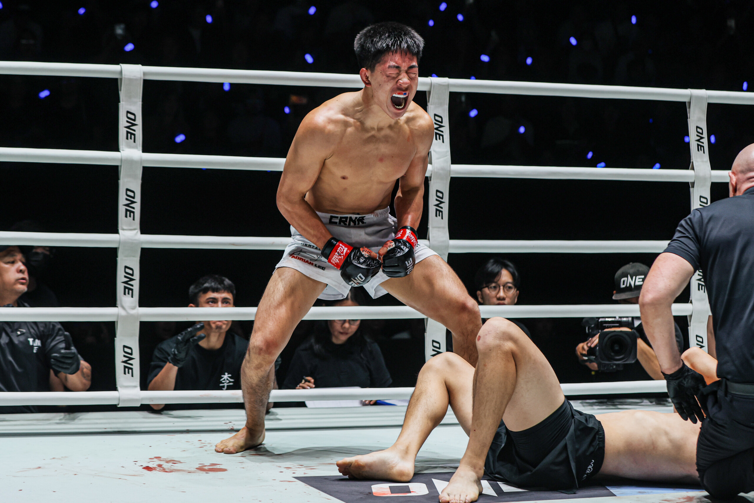 MMA fighter Adrian Lee screams in the ring following his win