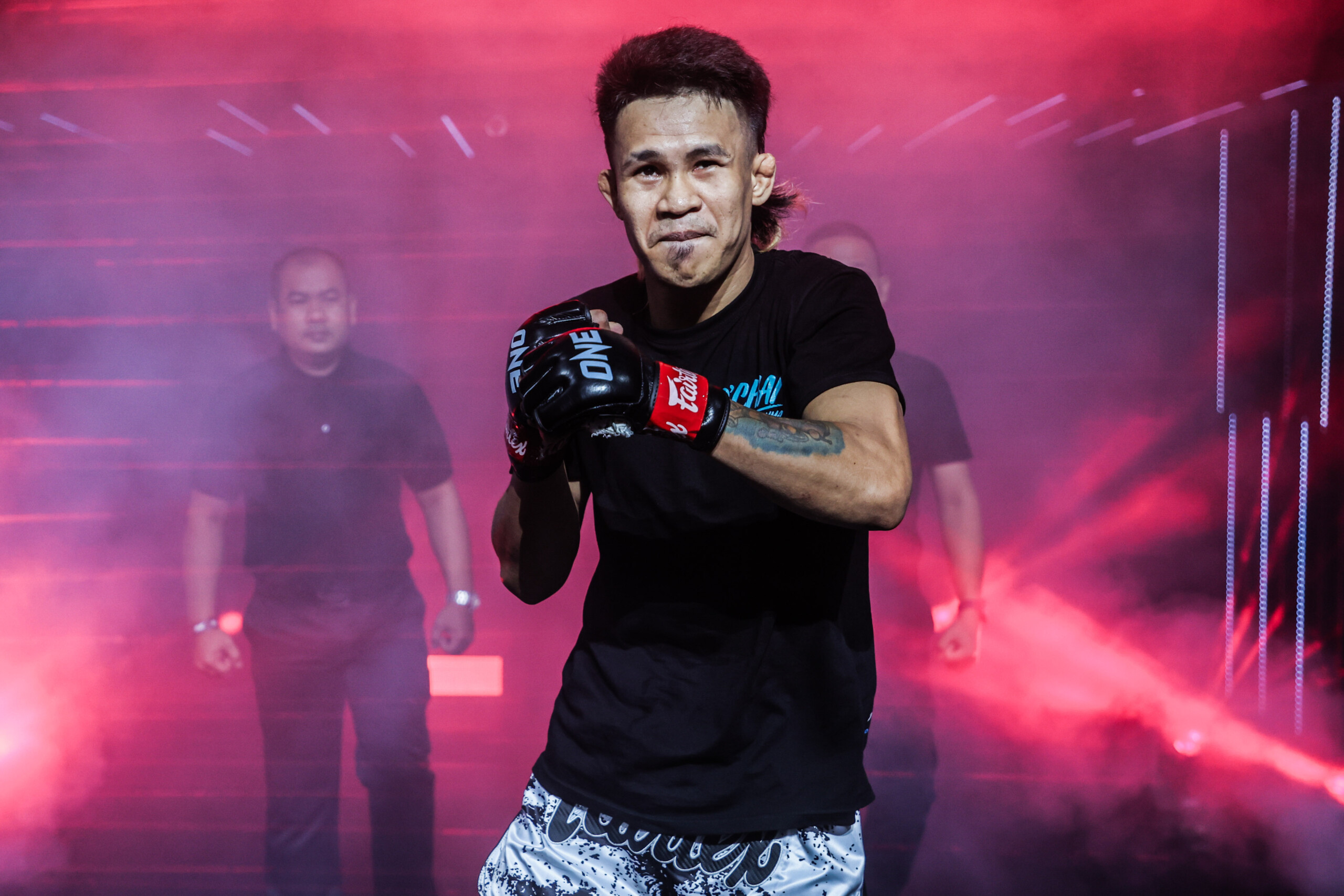 Filipino MMA fighter Jeremy Miado shadowboxes as he makes his entrance