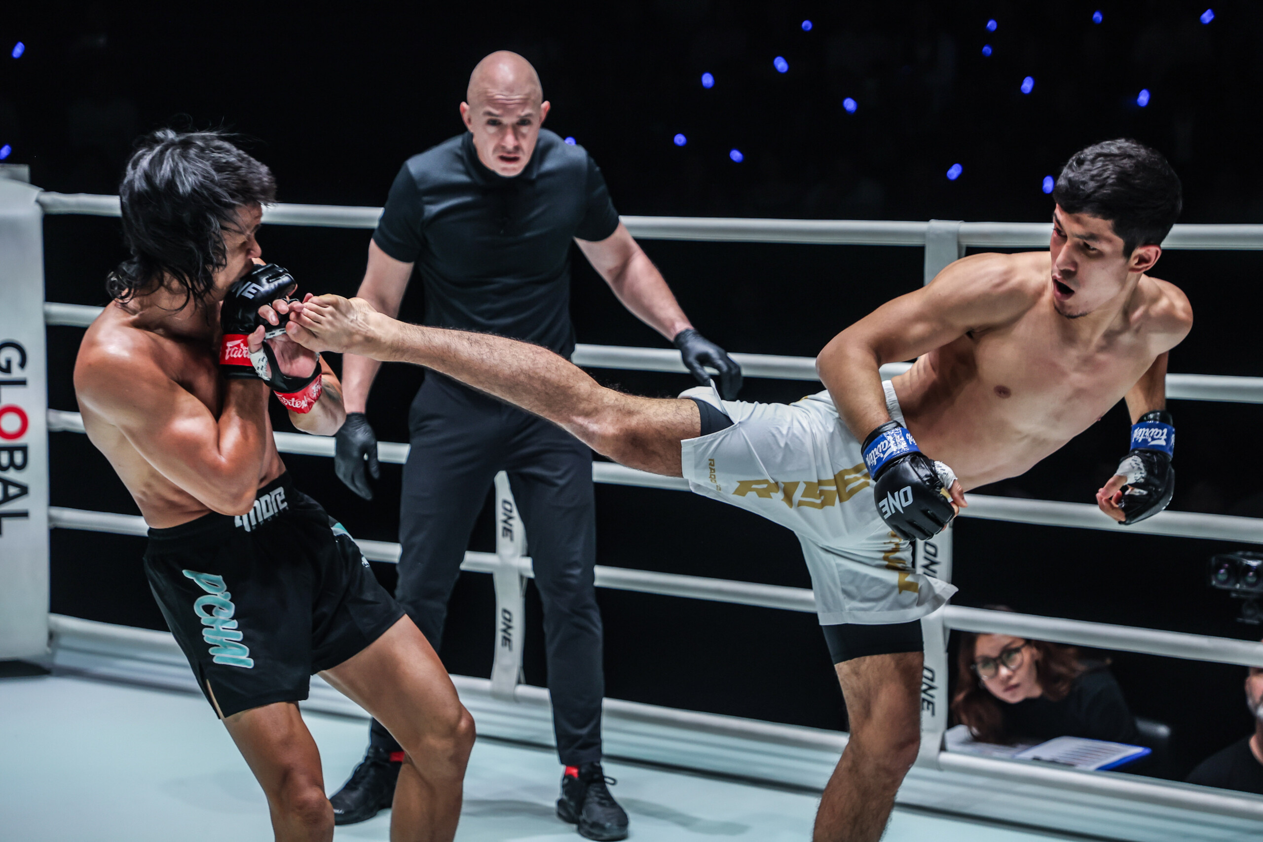 Uzbek MMA fighter Avazbek Kholmirzaev throws a spinning back kick at Jeremy Miado